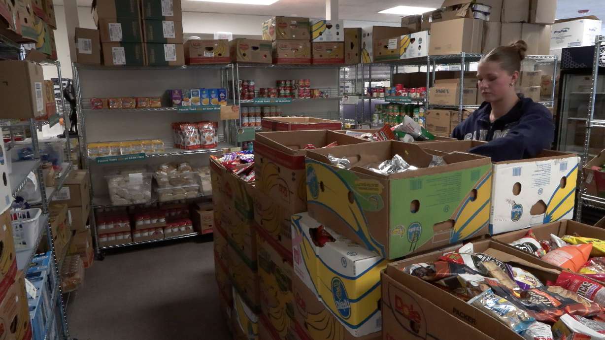 An employee at SNAC sorts food donations, Monday.