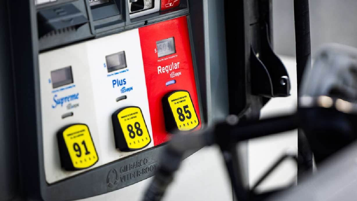 Gas prices are displayed as a gas pump refuels a car at a Holiday Chevron gas station in Herriman on Thursday, March 12, 2026.