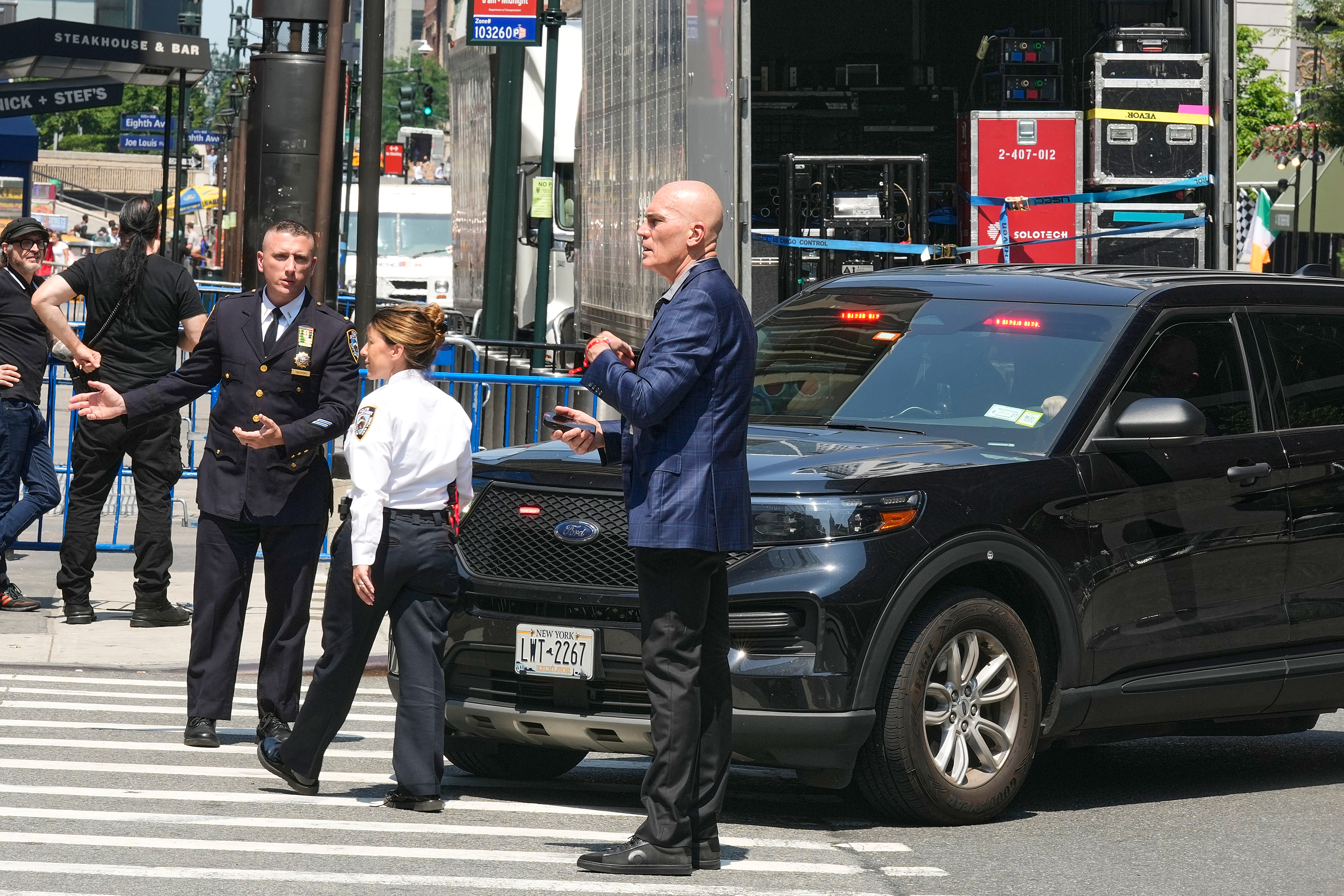 Security personnel meet outside New York's Madison Square Garden, Wednesday, July 1, 2026. 