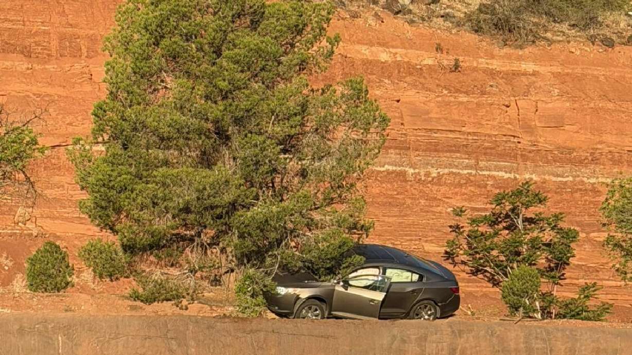 Driver arrested after crashing, nearly going off small cliff into traffic