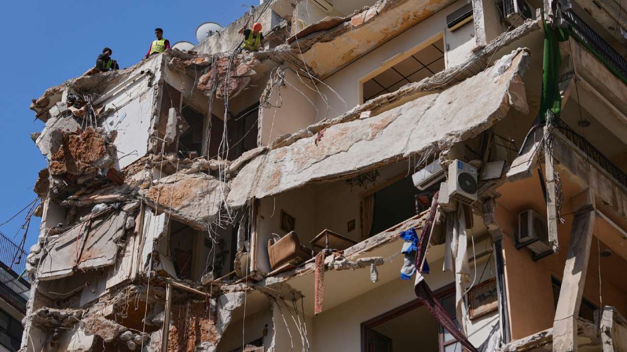 Workers remove the rubble as rescuers keep searching for a missing woman and girl at a destroyed building that was hit on April 8, in an Israeli airstrike in Beirut, Lebanon, Monday, April 13, 2026.
