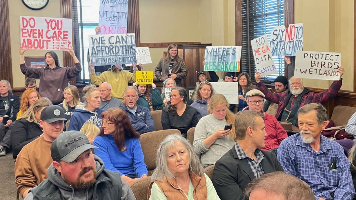 The photo shows protestors at the meeting, held at the Box Elder County Courthouse in Brigham City.