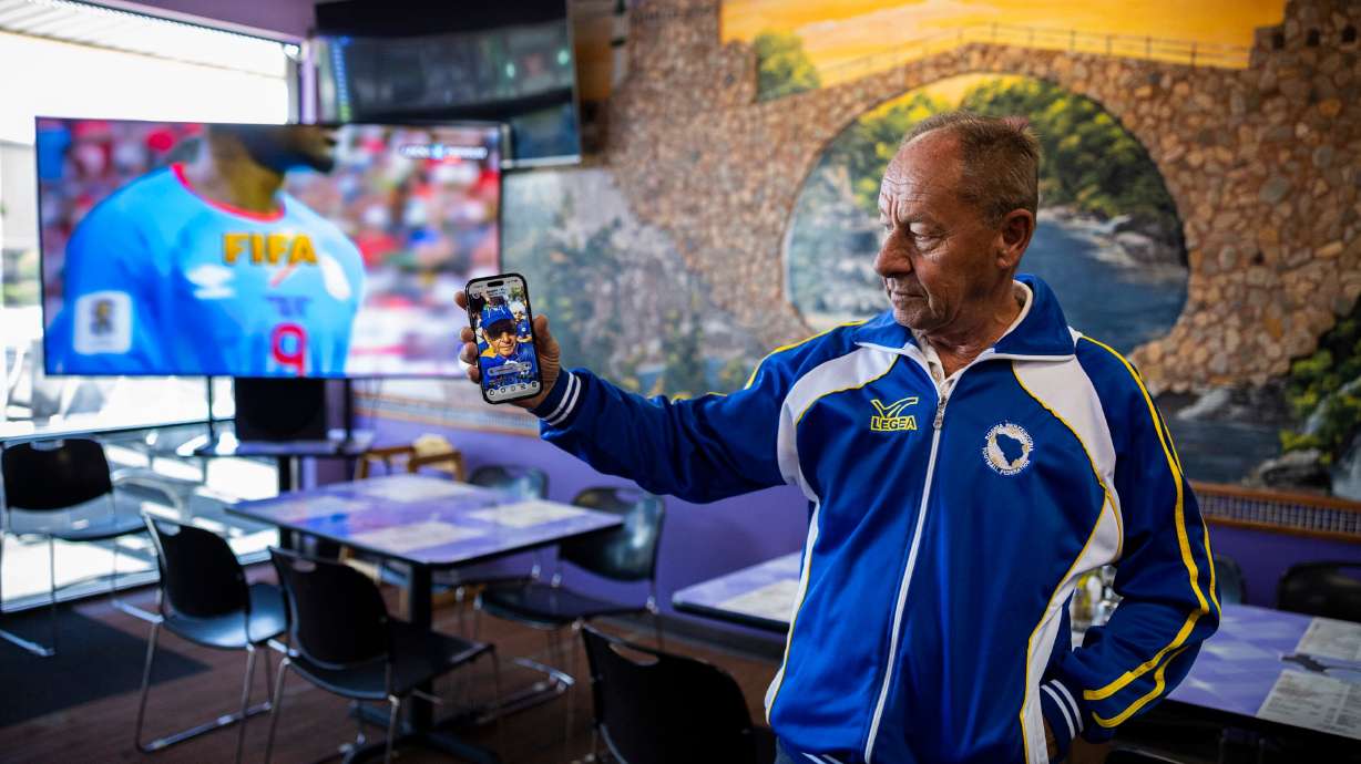 Ibro Sameric, owner of Old Bridge Cafe in South Salt Lake, shows a video Wednesday of himself celebrating with other fans in Seattle around the time of a Bosnia FIFA World Cup match held last week.