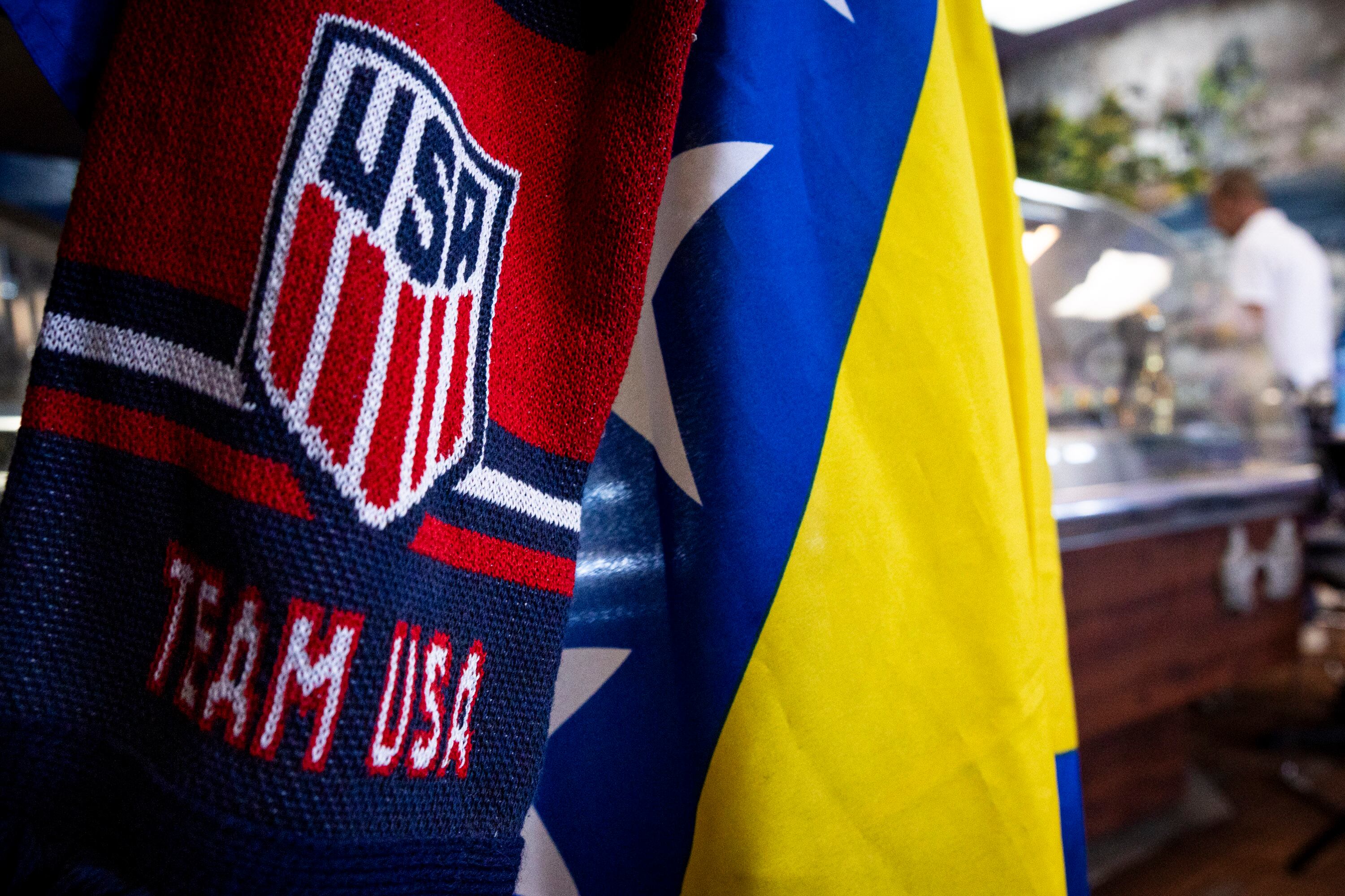 A scarf for the United States men’s national soccer team hangs with a Bosnia and Herzegovina flag at Old Bridge Cafe in South Salt Lake on Wednesday.