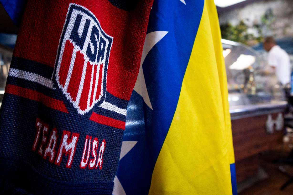 A scarf for the United States men’s national soccer team hangs with a Bosnia and Herzegovina flag at Old Bridge Cafe in South Salt Lake on Wednesday.