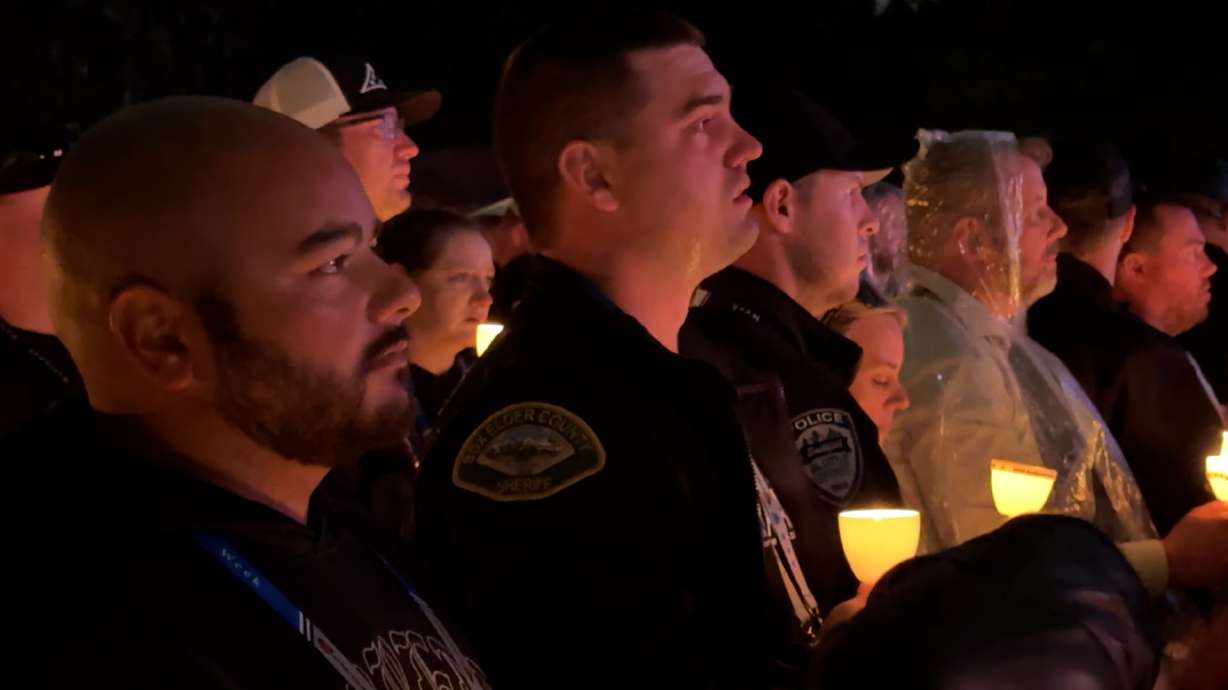 Families and colleagues honor fallen Tremonton-Garland officers during Police Week Candlelight Vigil.