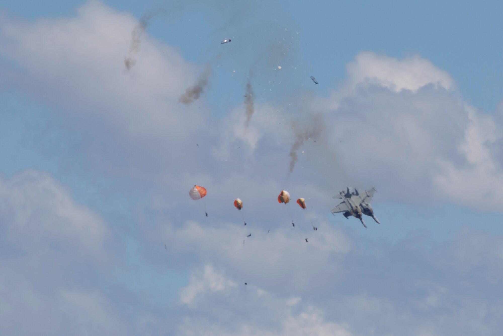 Crew members parachute down after two U.S. Navy planes collided during an air show at the Mountain Home Air Force Base, Sunday, May 17, 2026, near Mountain Home, Idaho.