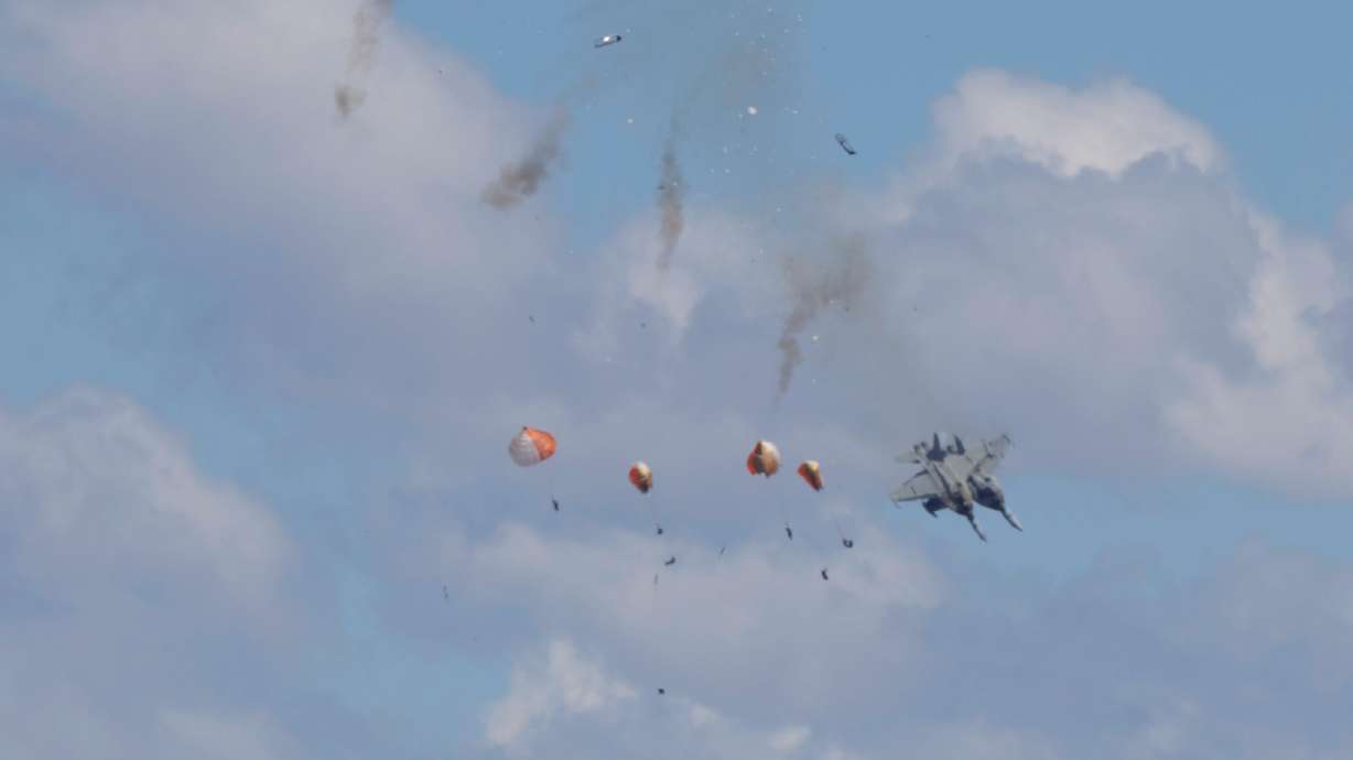 Crew members parachute down after two U.S. Navy planes collided during an air show at the Mountain Home Air Force Base, Sunday, May 17, 2026, near Mountain Home, Idaho.