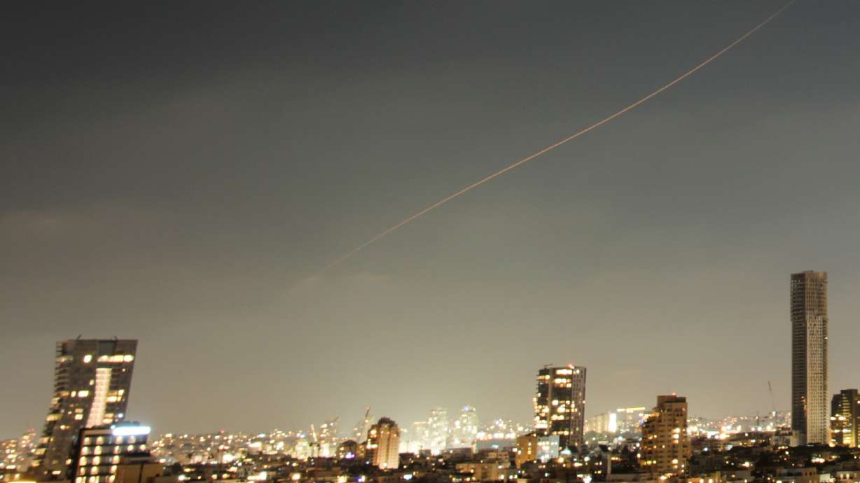 A projectile streaks through the sky over central Israel during an Iranian missile attack, Sunday, June 7, 2026.