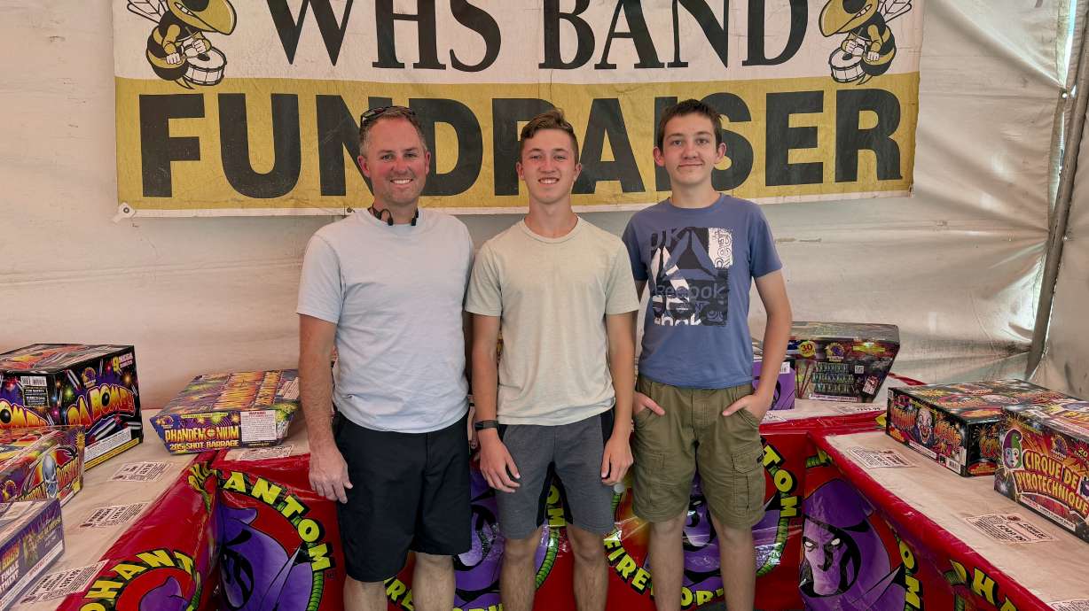 The Phantom Fireworks tent in the Smith's parking lot in Heber City, UT is staffed by volunteers from the Heber Valley Marching Band, who also benefit from sales of the stand as their fundraiser. Volunteers pose for a photo Wednesday.