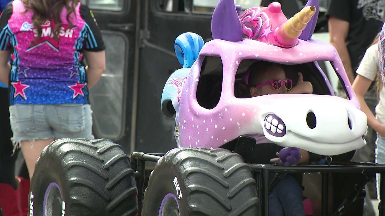 Kennedy Marples gives a thumbs-up as she wears a custom-made Sparkle Smash wheelchair costume made by Magic Wheelchair on Wednesday.