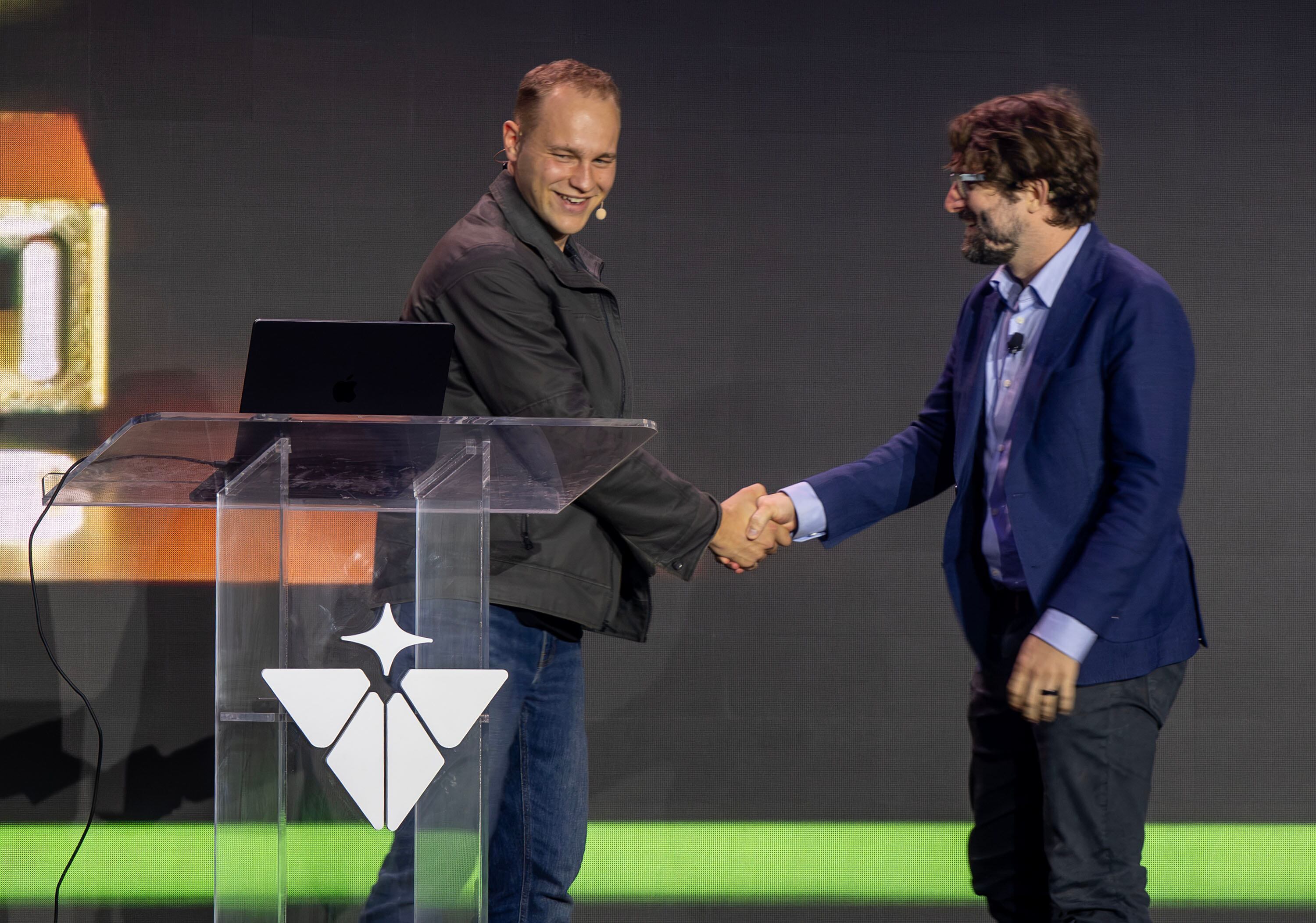 Isaiah Taylor, founder and CEO of Valar Atomics, shakes hands with Levi Patterson, director for energy, science, and artificial intelligence infrastructure policy in the Nvidia Corporation as they speak on stage as Valar Atomics and Nvidia celebrate a milestone in atomic energy and artificial intelligence at a large party gathering at the Orangeville site on Wednesday, July 1, 2026.