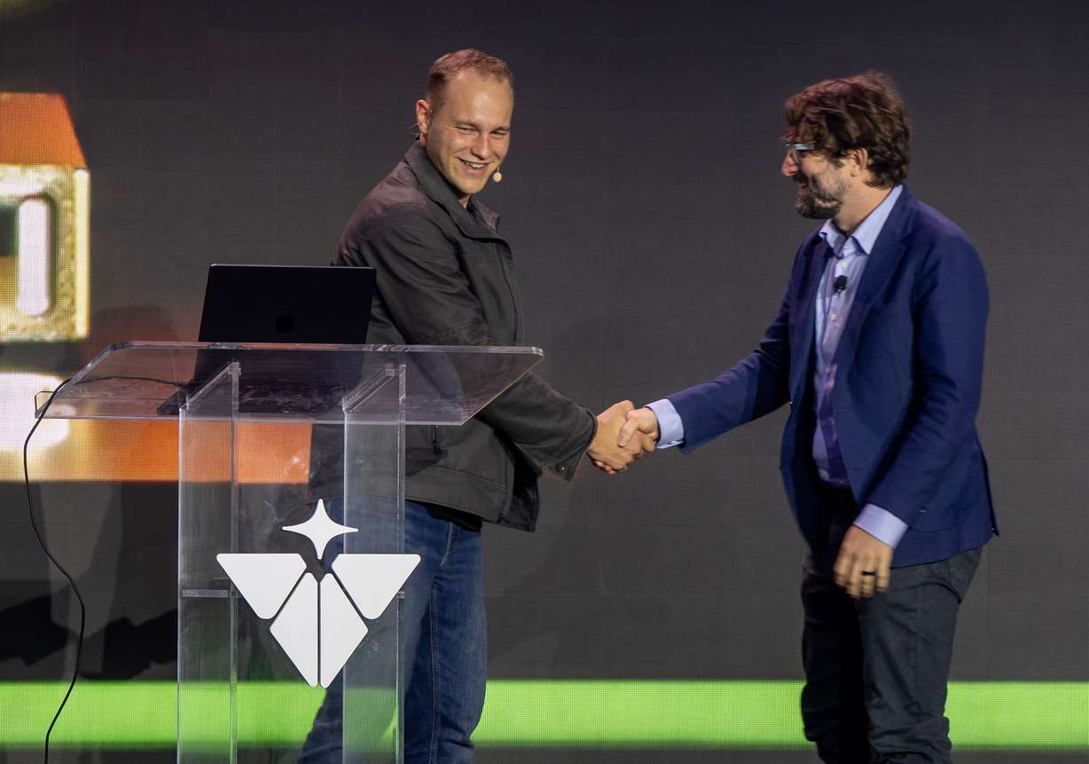 Isaiah Taylor, founder and CEO of Valar Atomics, shakes hands with Levi Patterson, director for energy, science, and artificial intelligence infrastructure policy in the Nvidia Corporation as they speak on stage as Valar Atomics and Nvidia celebrate a milestone in atomic energy and artificial intelligence at a large party gathering at the Orangeville site on Wednesday, July 1, 2026.
