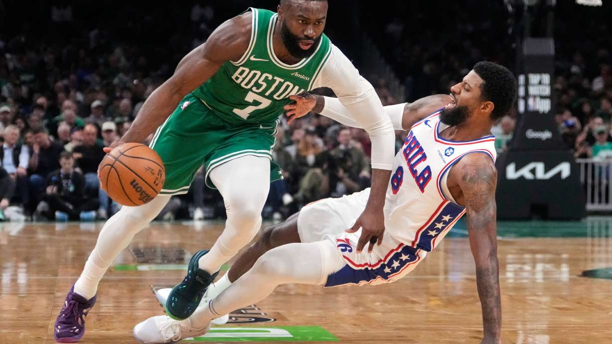 FILE - Boston Celtics guard Jaylen Brown (7) drives to the basket against Philadelphia 76ers forward Paul George (8) during the first half of Game 2 of a first-round NBA playoffs basketball series, April 21, 2026, in Boston.