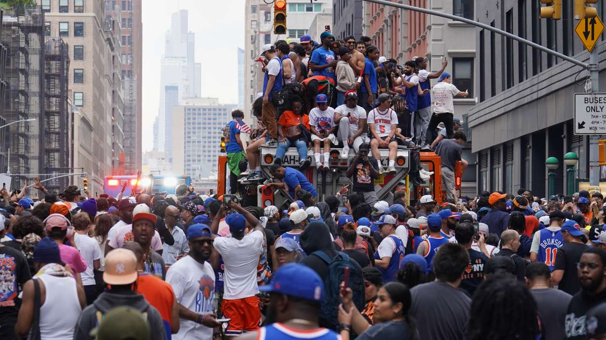 Fans celebrate during the New York Knicks' NBA championship parade Thursday, June 18, 2026, in New York.