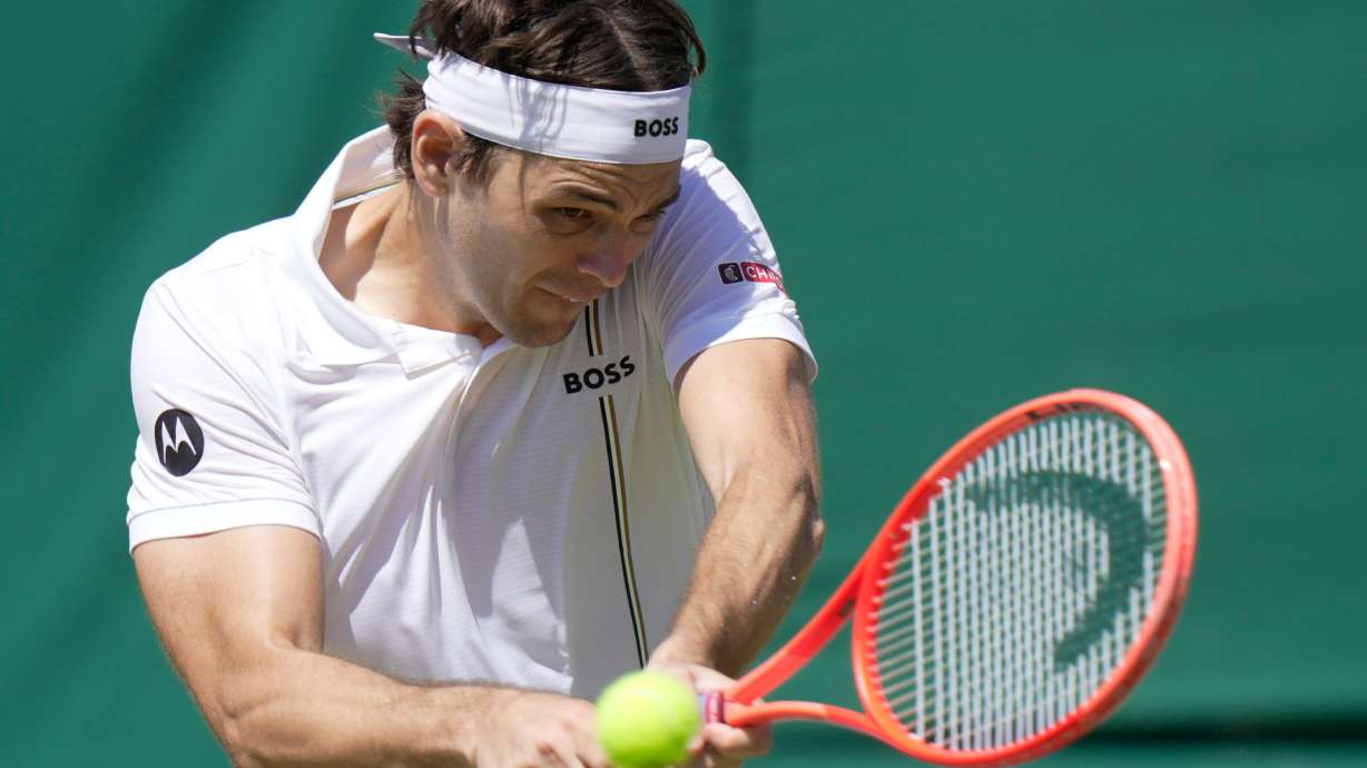 Taylor Fritz of the United States returns the ball to Patrick Kypson of the United States in their second round men's singles match at the Wimbledon Tennis Championships in London, Thursday, July 2, 2026.