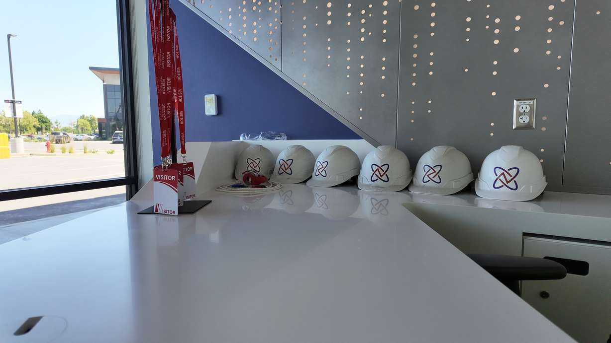 A set of Nusano-branded construction hats and lab passes is pictured at the company's headquarters in West Valley City on June 19, 2026.