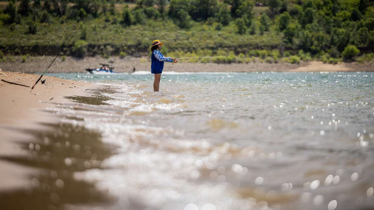 Cristal Watts, from Clinton, fishes at Pineview Reservoir in Ogden Valley on Thursday. The Utah Division of Wildlife Resources increased fishing limits at the reservoir as a result, as well as at six other bodies of water in Utah, on Thursday.