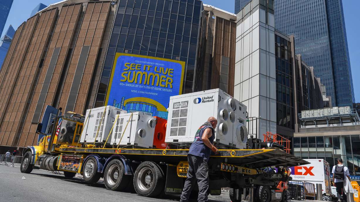 A worker unloads portable air-conditioning units outside of Madison Square Garden ahead of a reported wedding between singer Taylor Swift and National Football League player Travis Kelce on Thursday, July 2, 2026, in New York.