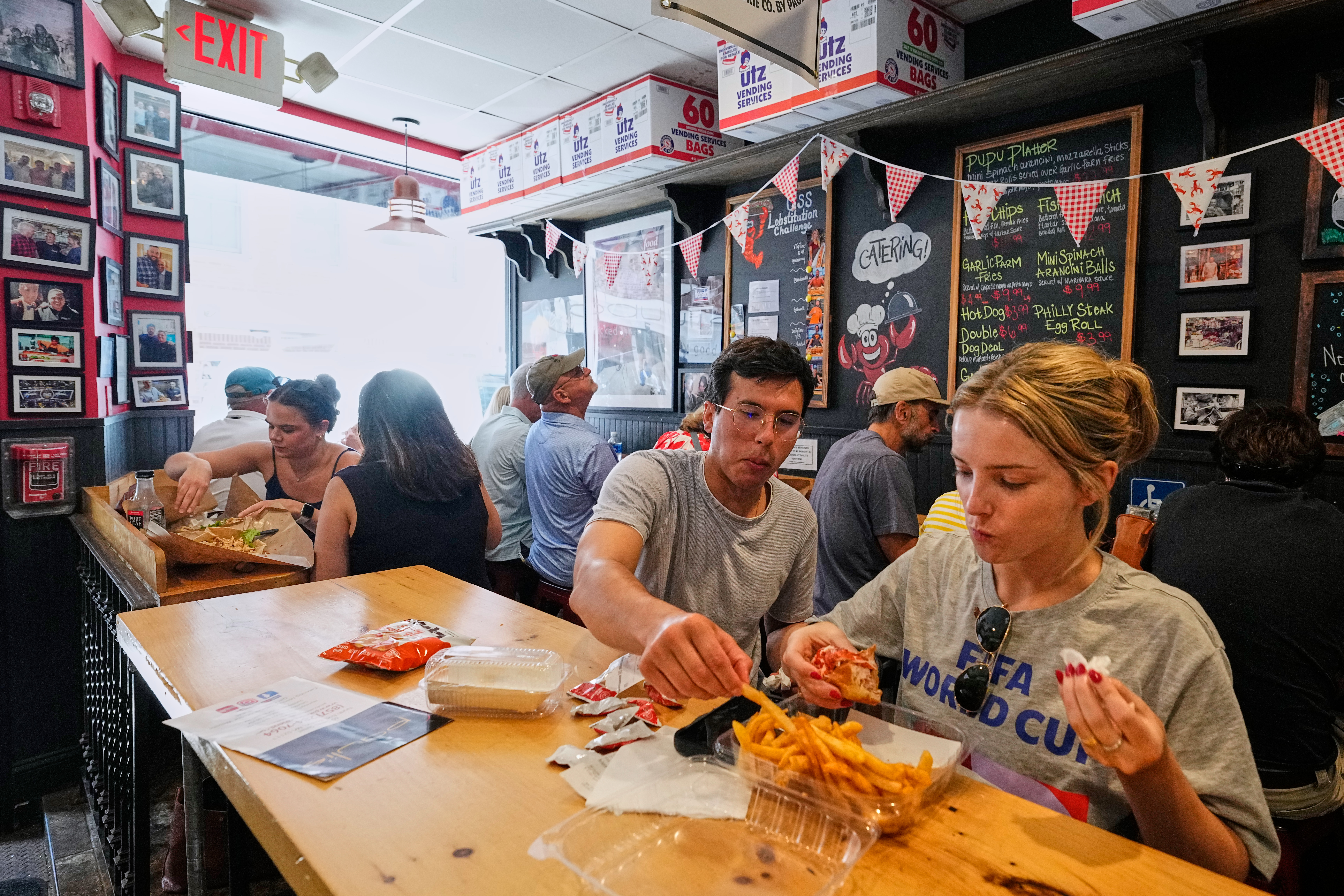 People wearing World Cup shirts taste sandwiches at Pauli's sandwich shop in the North End of Boston, Wednesday, June 24, 2026. 