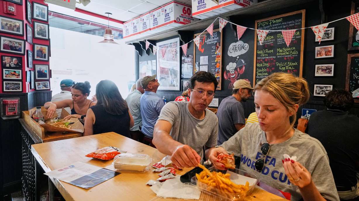 People wearing World Cup shirts taste sandwiches at Pauli's sandwich shop in the North End of Boston, Wednesday, June 24, 2026.