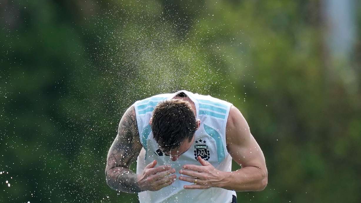Argentina's Lionel Messi spalshes water on his head to cool down during a training session on the eve of the team's World Cup round of 32 soccer match against Cape Verde, Thursday, July 2, 2026, in Fort Lauderdale, Fla.