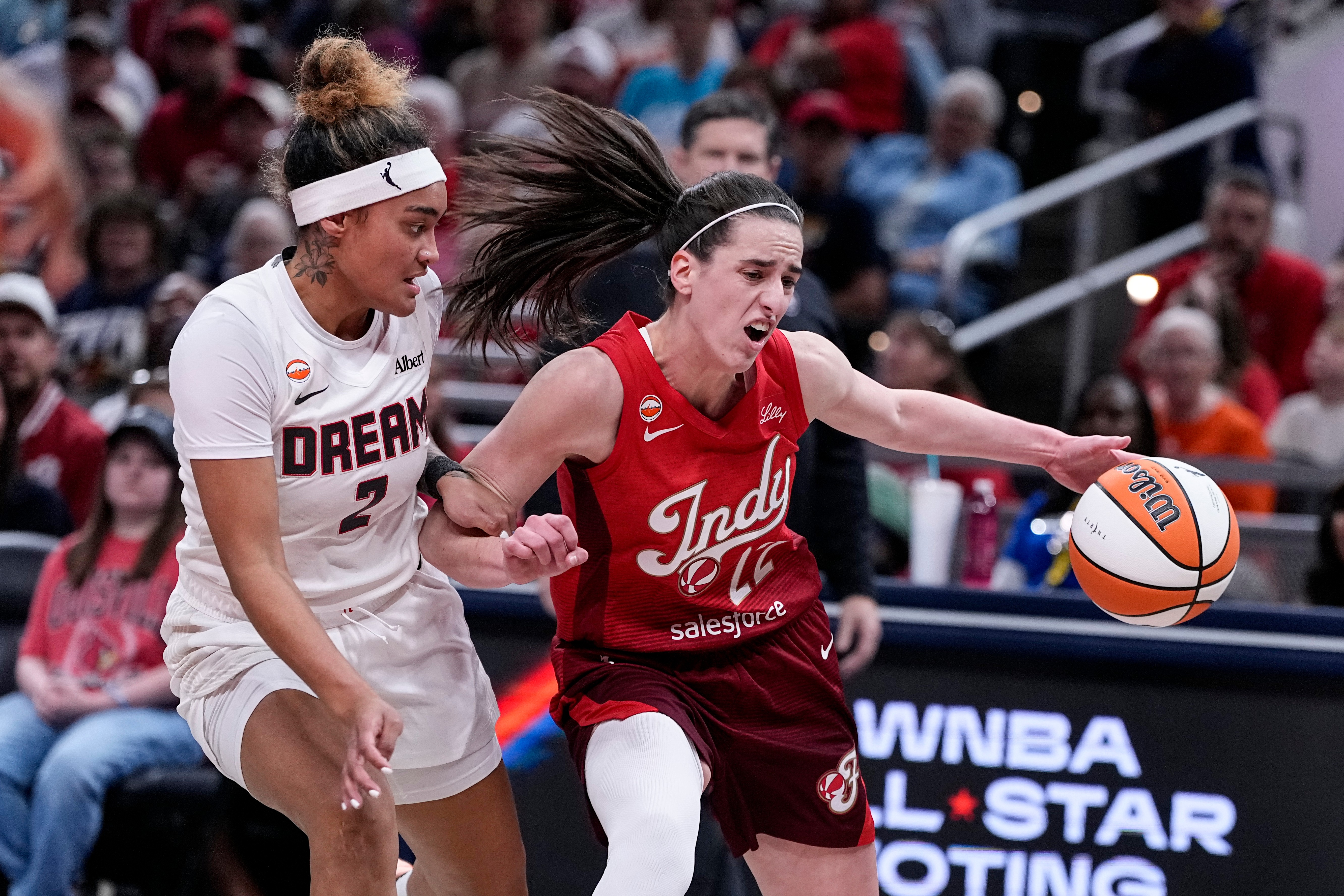 Indiana Fever guard Caitlin Clark (22) drives on Atlanta Dream guard Te-Hina Paopao (2) in the first half of a WNBA basketball game in Indianapolis, Thursday, June 18, 2026. 