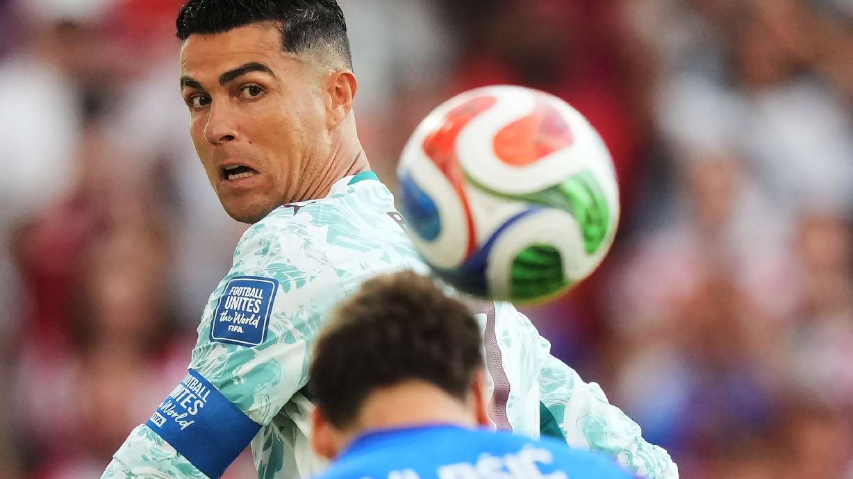 Portugal's Cristiano Ronaldo (7) watches as Croatia's Nikola Vlasic (13) heads the ball during the World Cup round of 32 soccer match between Portugal and Croatia in Toronto, Thursday, July 2, 2026.