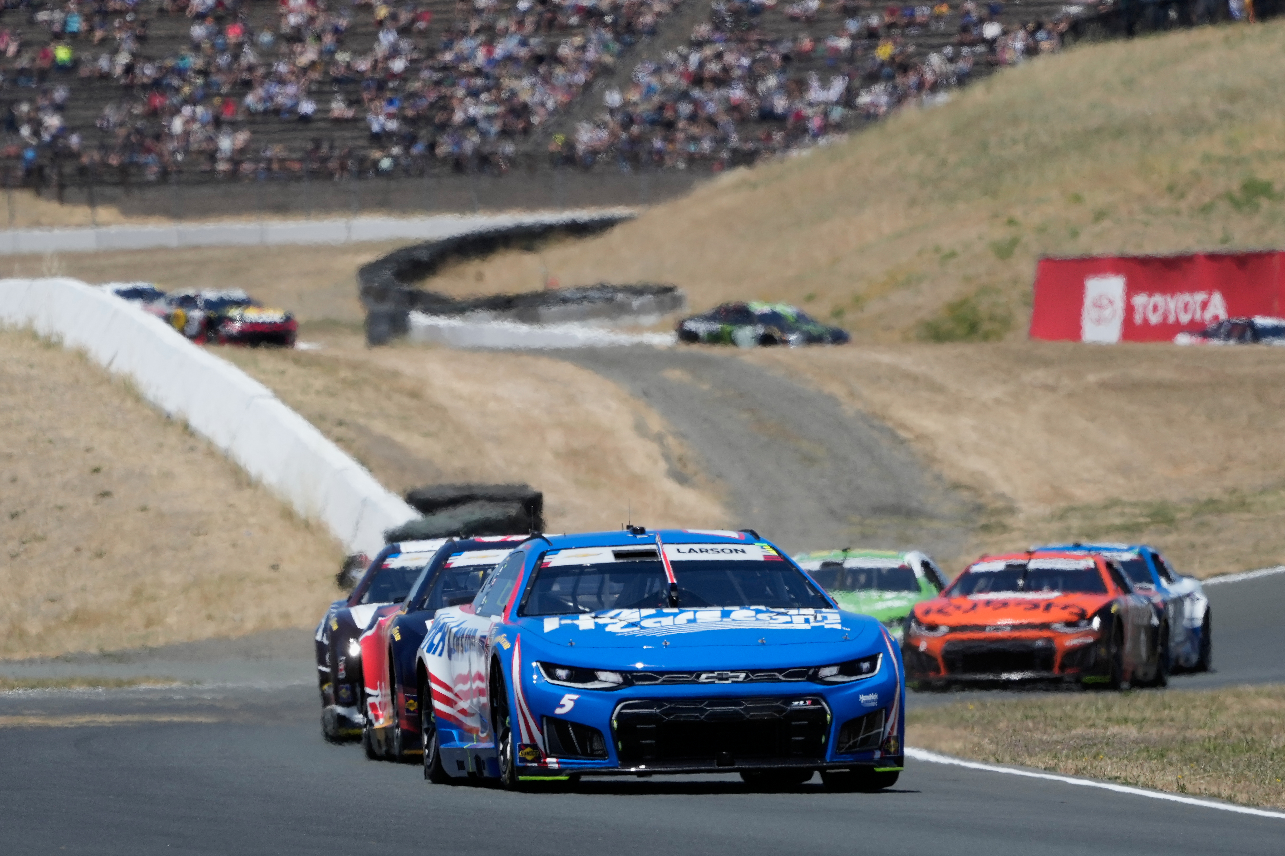Kyle Larson, foreground, drives in front of cars during a NASCAR Cup Series auto race at Sonoma Raceway, Sunday, June 28, 2026, in Sonoma, Calif. 