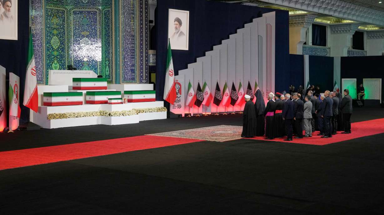 Iranian religious leaders and other mourners pay their respects before the coffins of Supreme Leader Ayatollah Ali Khamenei and members of his family during a viewing ceremony at the Imam Khomeini Mosalla Grand Mosque in Tehran, Friday. Khamenei's funeral began on Saturday, months after his death in an airstrike.