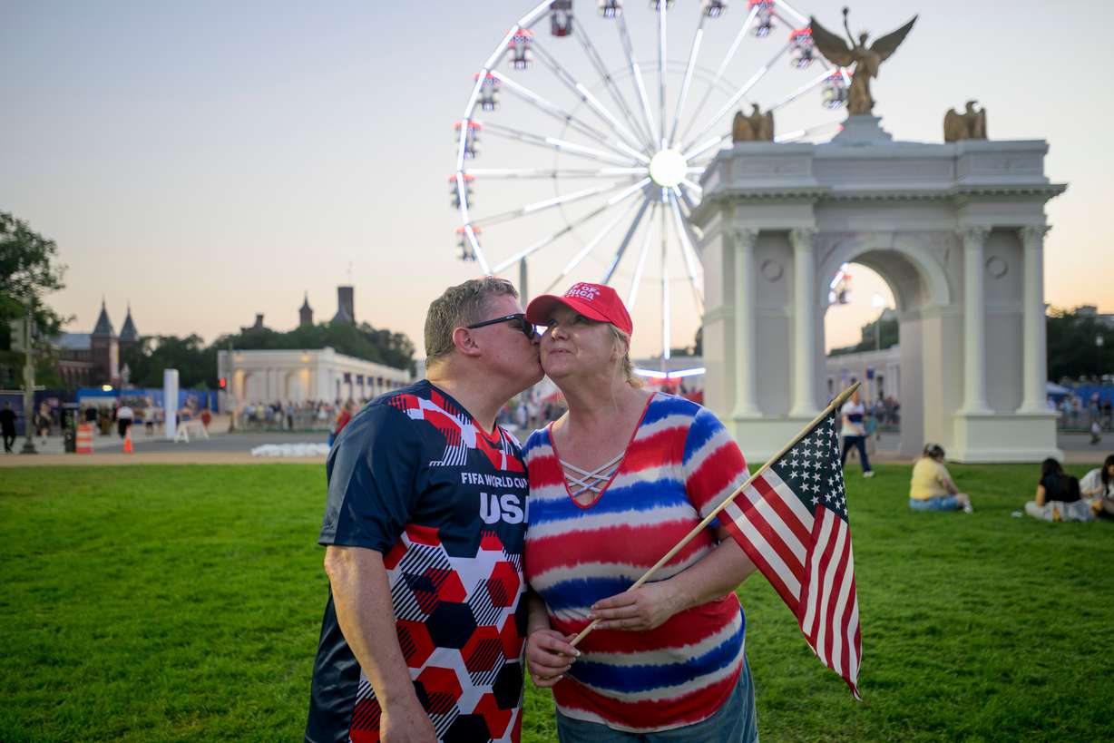 Todd Shaw kisses his wife Shannon Shaw as they pose for a portrait during the Great American State Fair on the National Mall, Thursday, in Washington. Anticipation for the celebrations has been building for months.