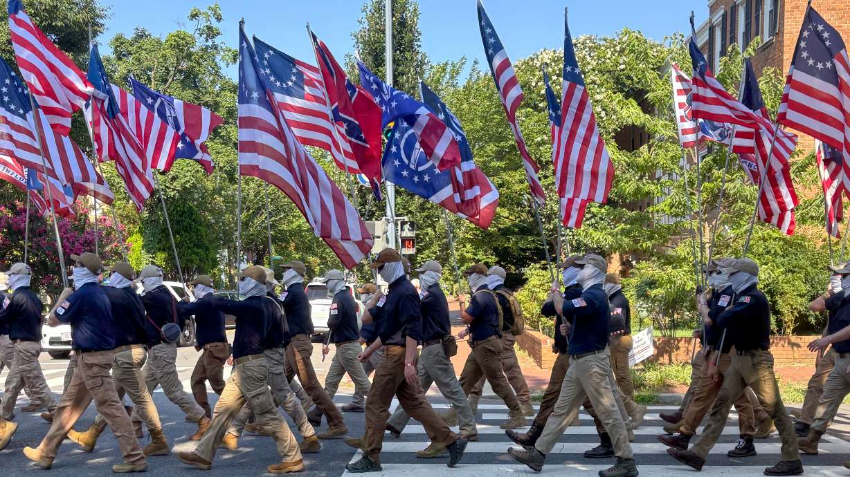 In this image provided by Mark Sherman, members of the group Patriot Front wear masks as they march through Washington before Independence Day events honoring the nation's 250th anniversary, Saturday.