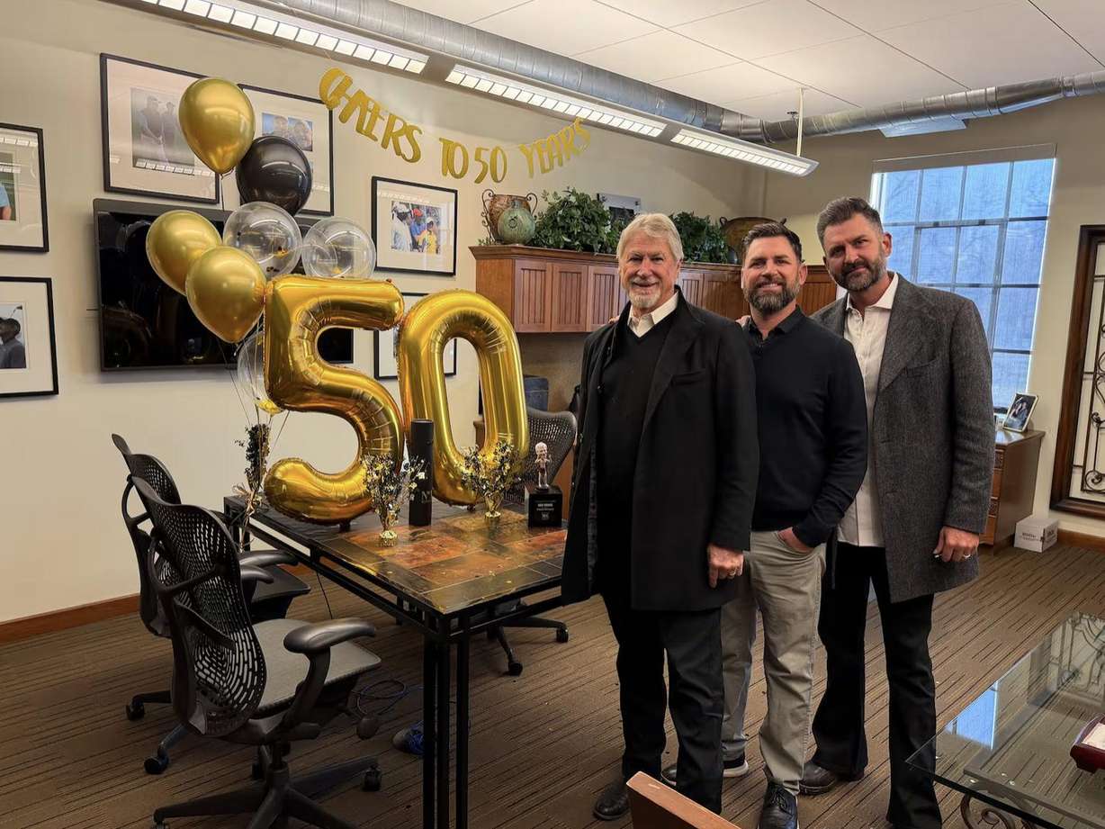 Rob Moore celebrates 50 years at Big-D Construction with his sons, Braden and Cory, both of whom also work for the company.