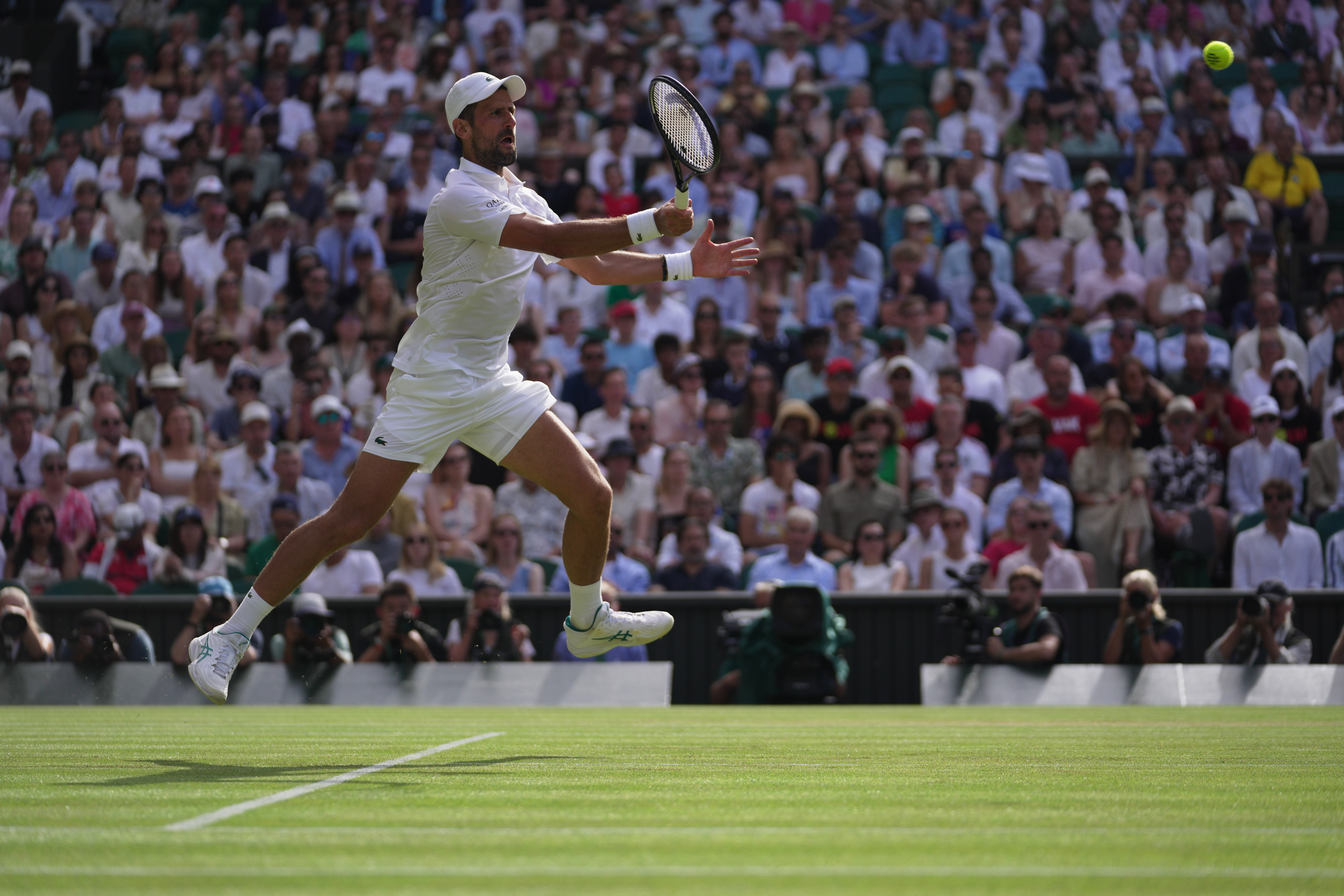 Novak Djokovic of Serbia returns the ball to Roman Saffiulin of Russia in their fourth round men's singles match at the Wimbledon Tennis Championships in London, Sunday, July 5, 2026. 