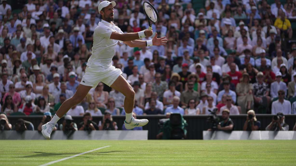 Novak Djokovic of Serbia returns the ball to Roman Saffiulin of Russia in their fourth round men's singles match at the Wimbledon Tennis Championships in London, Sunday, July 5, 2026.