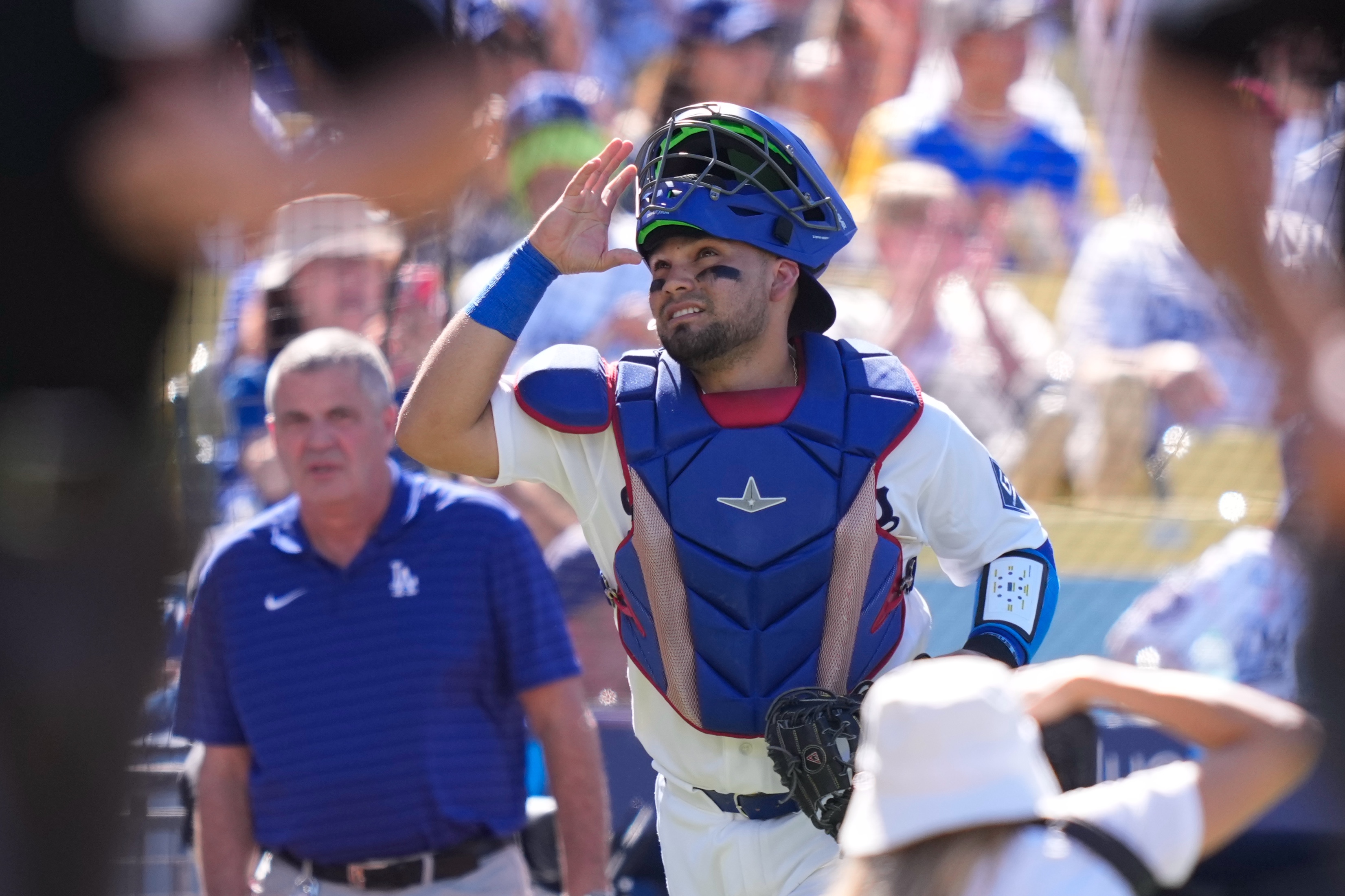 Los Angeles Dodgers catcher Eliezer Alfonzo looks toward the sky as he takes the field prior to a baseball game against the San Diego Padres, Sunday, July 5, 2026, in Los Angeles. 
