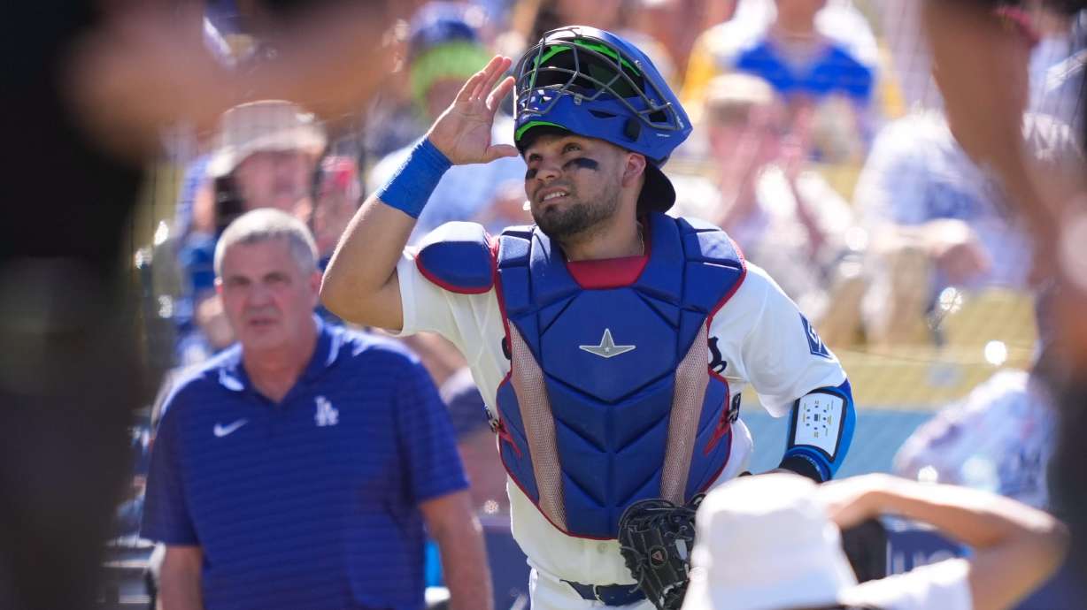 Los Angeles Dodgers catcher Eliezer Alfonzo looks toward the sky as he takes the field prior to a baseball game against the San Diego Padres, Sunday, July 5, 2026, in Los Angeles.