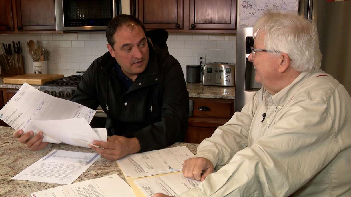 Robert Parkinson shows Matt Gephardt, KSL, a stack of papers, bills and collections notices.