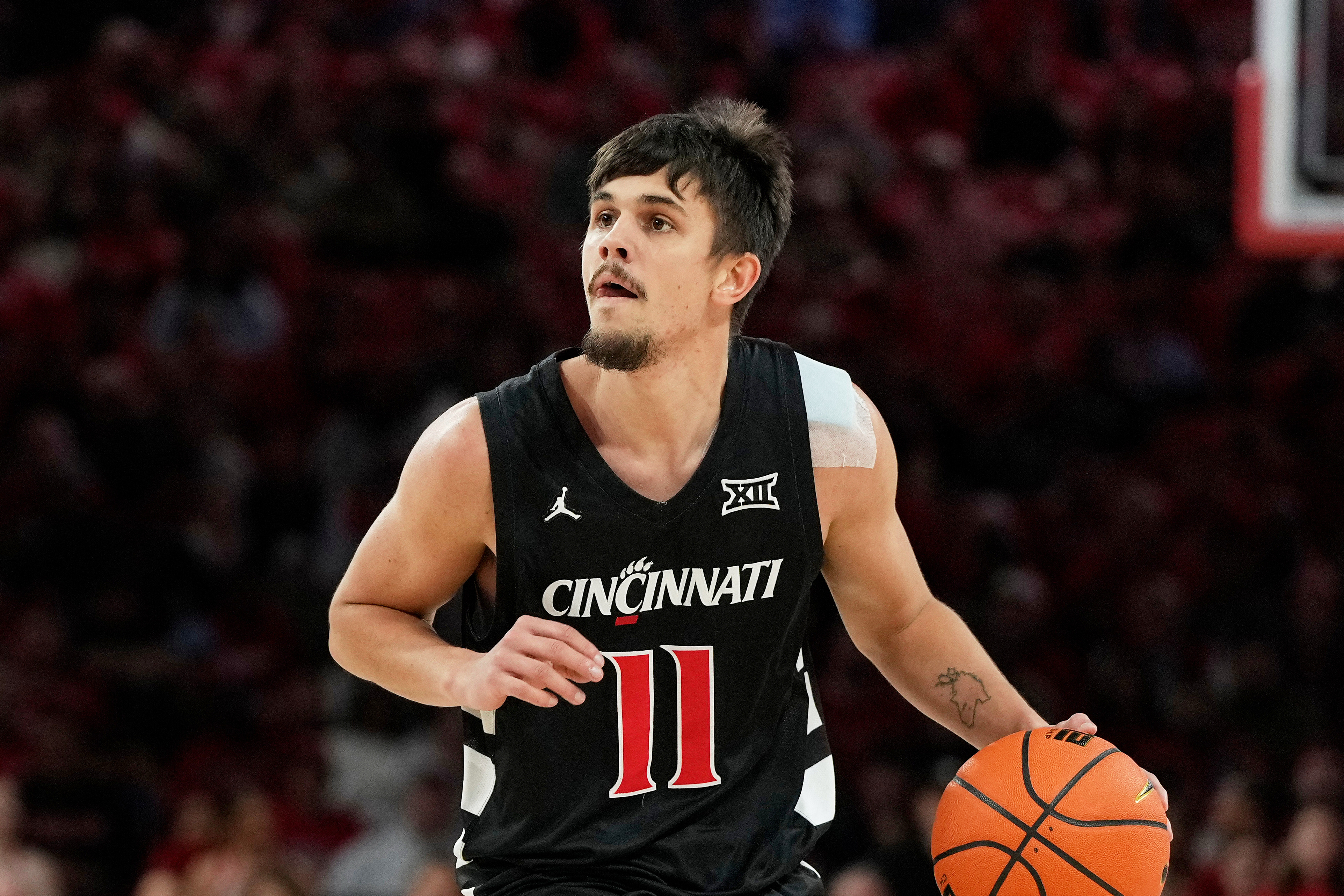 FILE - Cincinnati guard Kerr Kriisa (11) handles the ball during the first half of an NCAA college basketball game against Houston, Saturday, Jan. 31, 2026, in Houston. 