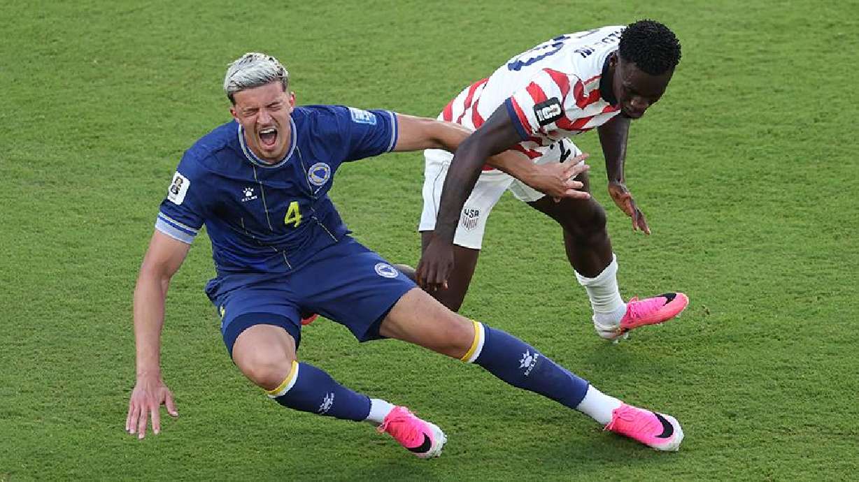 Folarin Balogun #20 of the United States fouls Tarik Muharemovic #4 of Bosnia and Herzegovina which is later reviewed by VAR and awarded as a red card foul during the FIFA World Cup 2026 Round of 32 match between USA and Bosnia and Herzegovina at San Francisco Bay Area Stadium on July 1 in Santa Clara, Calif.