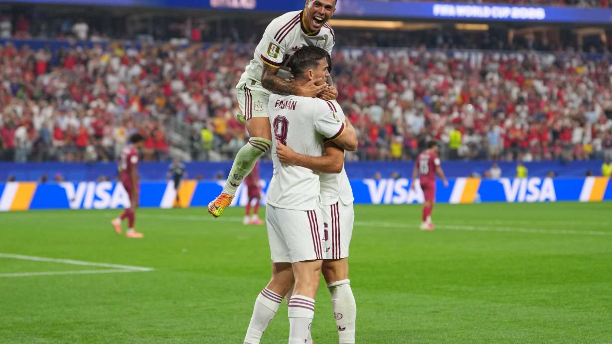 Spain's Pedro Porro, top, congrats Spain's Mikel Merino, right, after scored during the World Cup round of 16 soccer match between Portugal and Spain in Arlington, Texas, near Dallas, Monday, July 6, 2026.