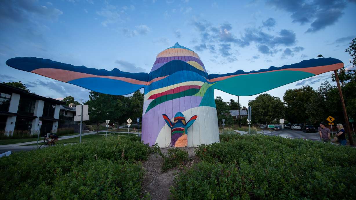 Michael Claflin's miniature version of "Out of the Blue" stands next to the original sculpture in Salt Lake City on Wednesday. Claflin said he's surprised that his version ended where it did, and by the viral reaction his small creation has created.