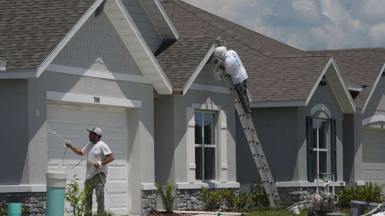 Workers put the final touches on a new single family home, July 30, 2025, in Zephyrhills, Fla. There are so many houses for sale in Florida that a national housing analyst is warning that the Sunshine State's "market is flashing warning signs."