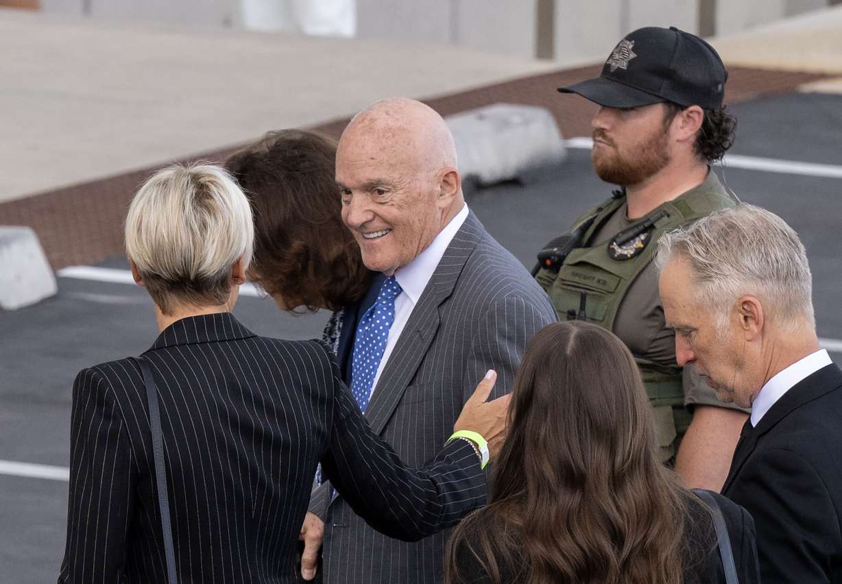 Robert and Kathryn Kirk, parents of Charlie Kirk, enter the 4th District Courthouse in Provo, surrounded by media, ahead of a preliminary hearing for Tyler Robinson, who is charged in the killing of Charlie Kirk, on Monday.