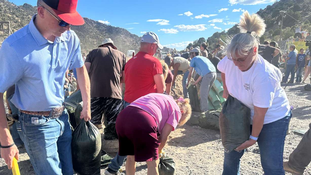Volunteers fill sandbags in Eureka on Monday. After being evacuated twice in one week because of two different wildfires, residents in and around Eureka are already taking steps to prepare for the next potential threat: flooding.