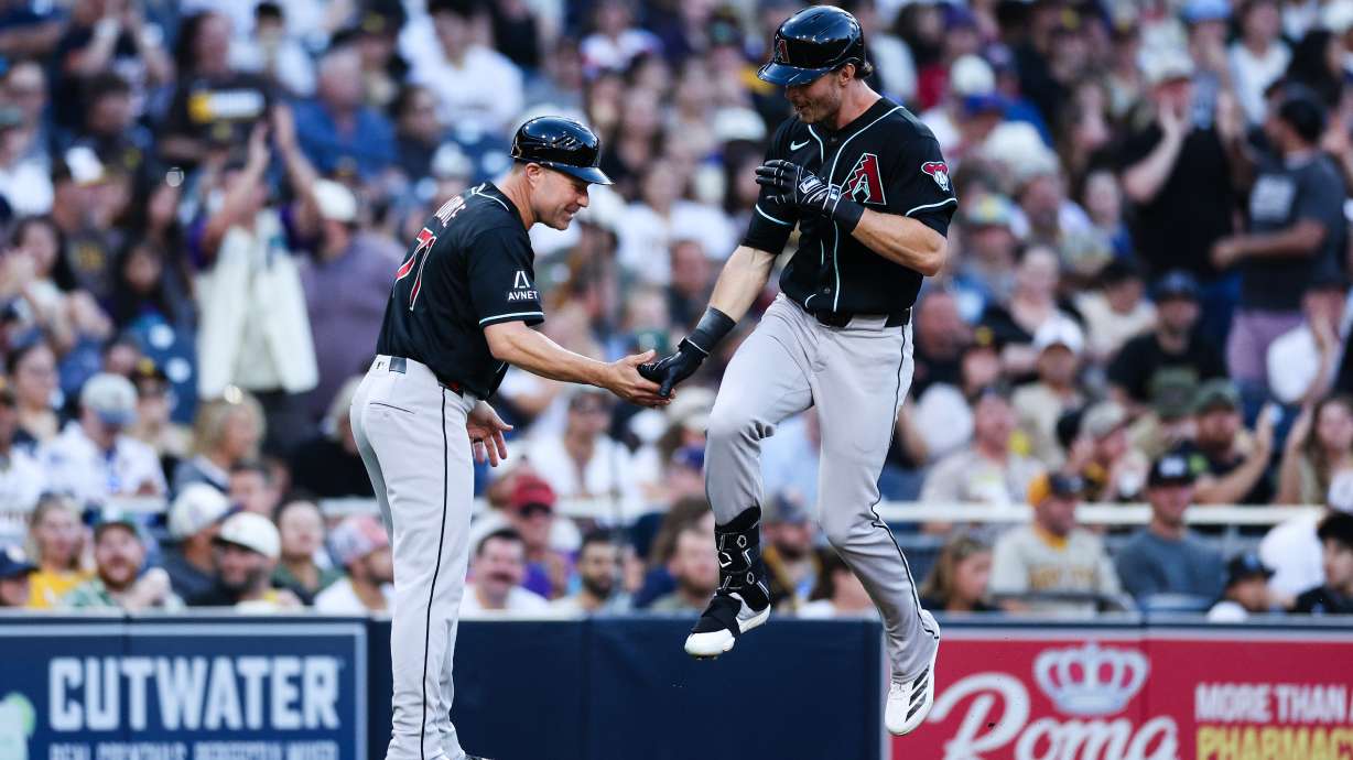 Arizona Diamondbacks' Max Kepler, right, is congratulated by third base coach J.R. House, left, after hitting a three-run home run against the San Diego Padres in the third inning of a baseball game Monday, July 6, 2026, in San Diego.