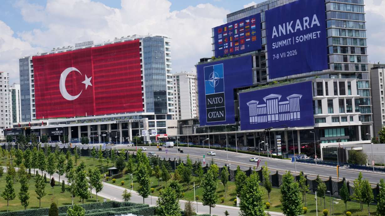A Turkish flag and NATO banners cover buildings ahead of the NATO Summit in Ankara, Turkey, Monday.