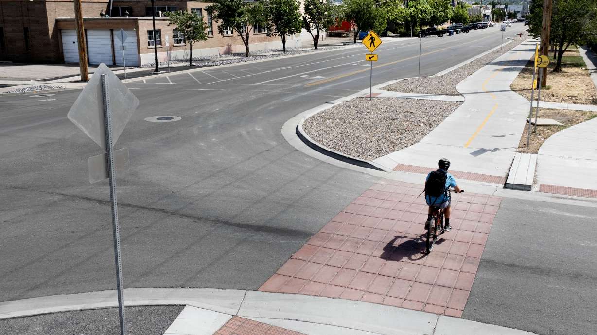A cyclist uses the 9-Line Trail at the intersection of 900 South and 500 West in Salt Lake City on Aug. 15, 2024. Salt Lake City received an $11.5 million grant on Tuesday that will help add more trees along the trail, among other things.