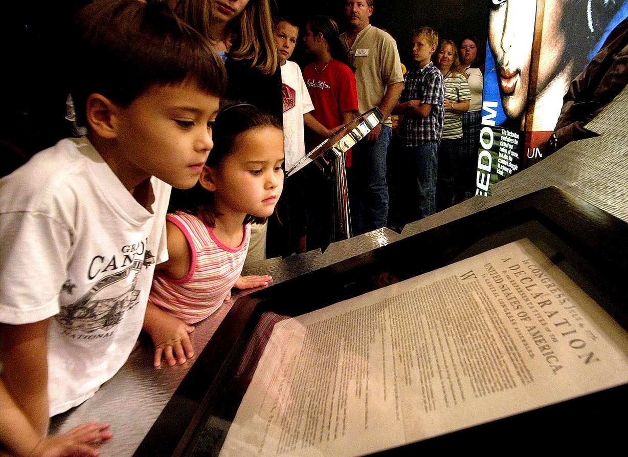Conor Park, 8, and his sister Ripley Park, 7, look at an original printed version of the Declaration of Independence at the Capitol in Phoenix, Oct. 8, 2003.