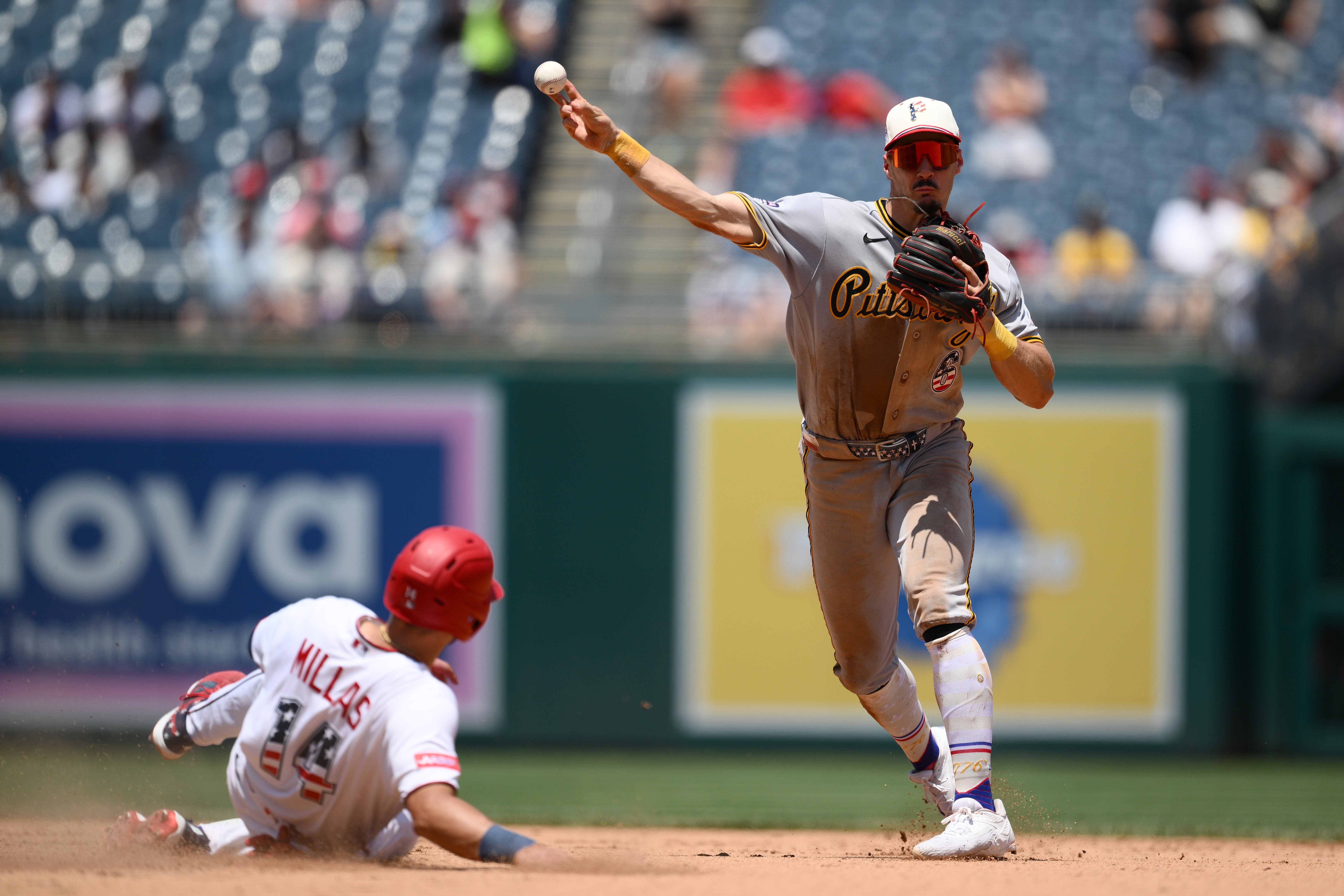 Washington Nationals' Drew Millas is out at second base as Pittsburgh Pirates shortstop Konnor Griffin throws to first base to put out Nationals' Nasim Nunez during the seventh inning of a baseball game, Saturday, July 4, 2026, in Washington. 